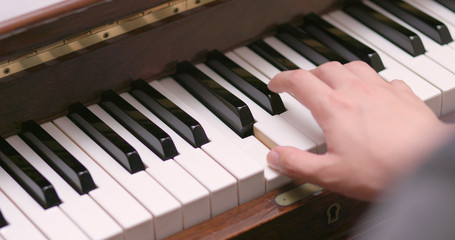 Fototapeta premium Man practicing piano at home
