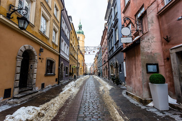 Snowy alley in downtown Warsaw during january, mid winter, christmas decorations are still up