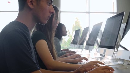 Students studying with computers - Powered by Adobe