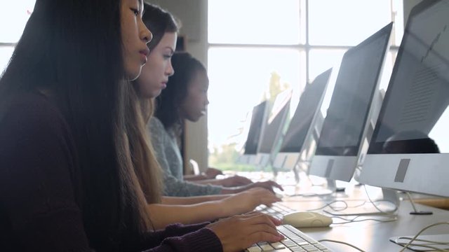 Female students studying with computers