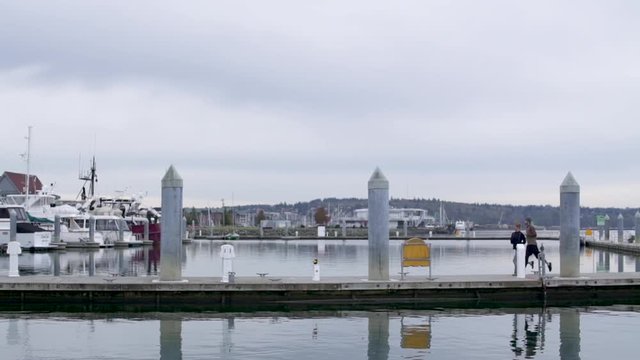 Couple jogging over pier and bridge in harbor.
