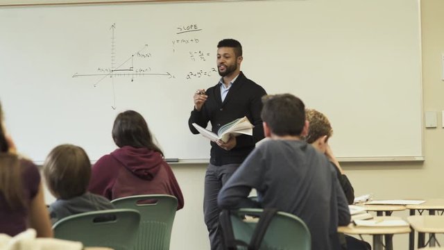 Medium shot of teacher holding math class
