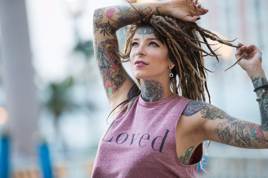 Beautiful hippie girl with tattoos and dreadlocks