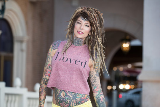 Beautiful hippie woman with tattoos and dreadlocks