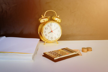 alarm clock old vintage gold, money and calculator over white and black background. with copy space add text retro style
