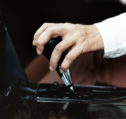 Woman holding on to a gearstick