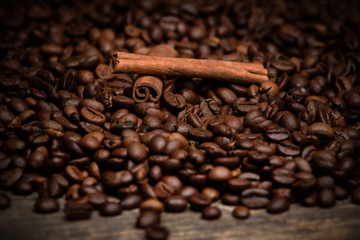 Freshly roasted coffee beans on an old wooden background