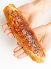 Buns with raisins in a hand on a white background