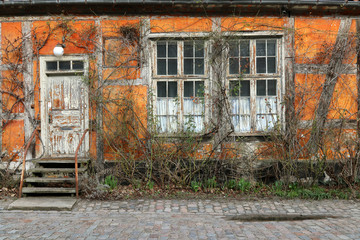 Fototapeta na wymiar Old yellow house facade. Uninhabited.