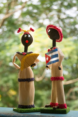 Cuban craft puppets, she with fan and him with Cuban flag