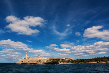 Obraz premium Morro Castle of Havana and its lighthouse with clouds in blue sky