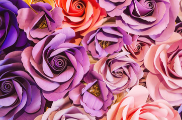 Backdrop of colorful paper roses background in a wedding.