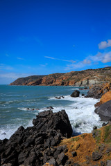 Portuguese coastline with the ocean and the sintra mountains in background. Cascais Portugal