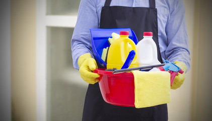 man with bucket and cleaning products in the house