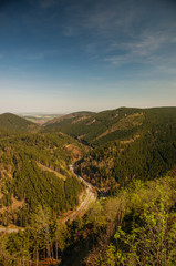 Fototapeta na wymiar Panorama valley view from a mountain top cliffs in spring with blue sky. Ahrendsberger Klippen, Okertal, Okertalsperre, Oker (Goslar) National Park Harz 
