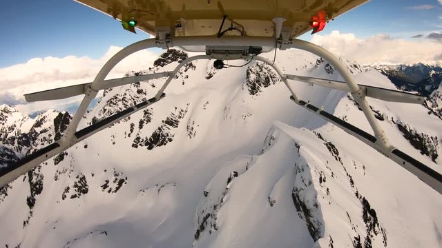 Helicopter POV Flying View Above Snowy Mountain Crater Jagged Cliff Peaks Three Fingers Washington Cascade Mountains