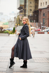 Fototapeta premium Portrait of a young beautiful woman in gray coat