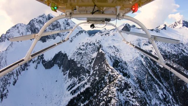 Three Fingers Mountain Peak Winter Snow Flying in Helicopter Aerial View Looking Backwards