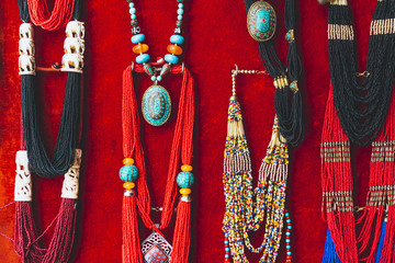 Colorful traditional  souvenir Necklaces are sold on the tourist market in Kathmandu, Nepal. Contain of ornaments and small figures.