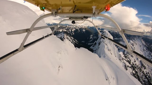 Unreal Extreme Helicopter Flight Between Soaring Mountain Heights Steep Jagged Snowy Peaks Cascade Mountains Unique Angle Looking Backwards Three Fingers Washington USA Winter Exploring Unknown