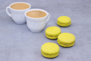 Macaroni cakes on a gray concrete background.