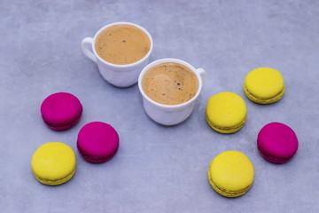 Macaroni cakes on a gray concrete background.