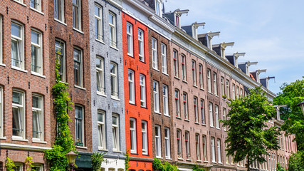 Fototapeta na wymiar Colourful line of houses in Amsterdam, Netherlands