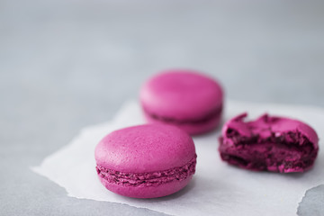 Macaroni cakes on a gray concrete background.