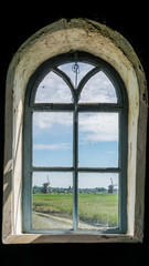 Windmill framed in a window in Kinderdijk, Netherlands