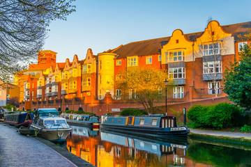 Sunset view of brick buildings alongside a water channel in the central Birmingham, England