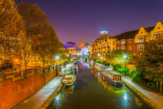 Night view of brick buildings alongside a water channel in the central Birmingham, England