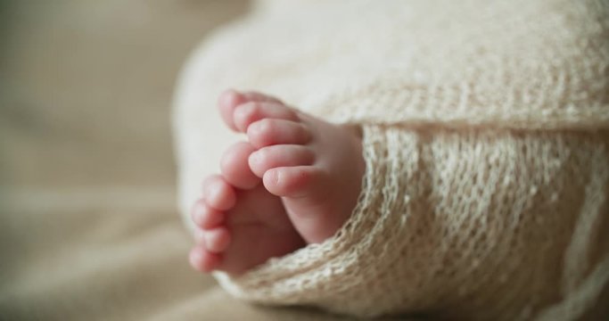 4k, newborn baby's legs close-up