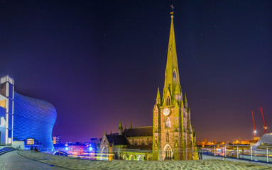 Night view of Saint Martin church surrounded with Bullring shopping mall in Birmingham, England