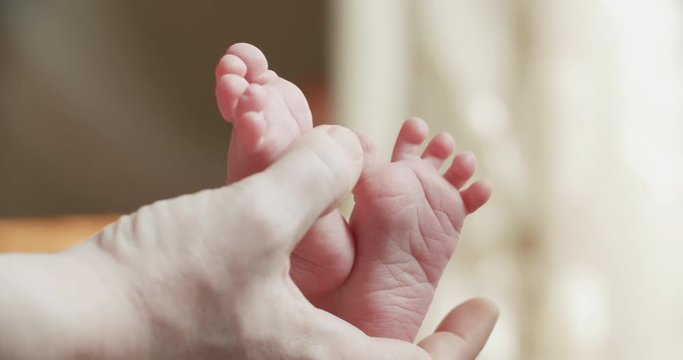 4k, a newborn baby holds a close-up in the mother's hands, slow motion