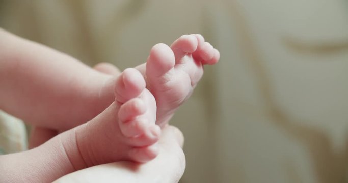 4k, a newborn baby holds a close-up in the mother's hands, slow motion, maternity concept
