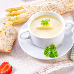 asparagus cream soup with capers and fresh baguette