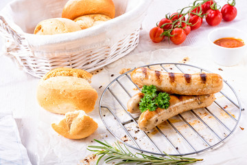 delicious bratwurst with ketchup and fresh rolls