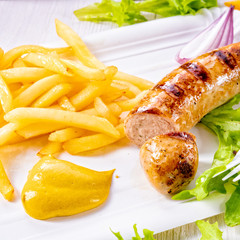 delicious grilled bratwurst with fries and mustard