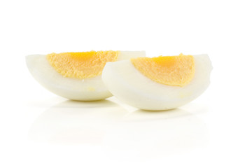 Two boiled chicken egg slices isolated on white background.