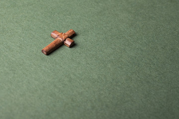 Christian cross on green background with space for writing