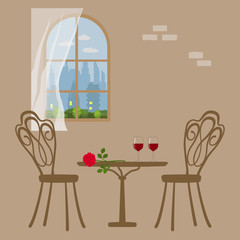 Table in restaurant, served for romantic dinner. On the background of the window in which you see the evening twilight, the glowing windows of houses and the evening cityscape.