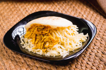 Venezuelan breakfast, Arepa, corn tortilla with chicken and yellow cheese