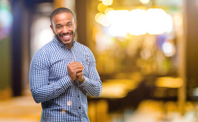 African american man with beard confident and happy with a big natural smile at night