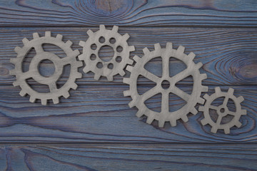 Gear wheels on a wooden background. The concept of creative, logical thinking. Logic background. gears of natural wood