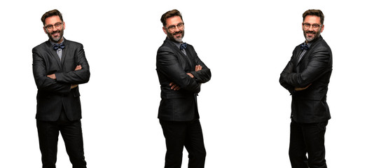 Middle age man, with beard and bow tie with crossed arms confident and happy with a big natural smile laughing