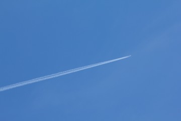 Plane on blue sky, background air transport.