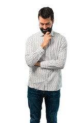 Handsome man with beard standing and looking down