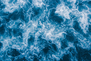 Naklejka na ściany i meble Abstract blue sea waves with white foam for background, natural summer background, pattern concept