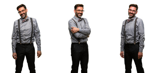 Middle age man, with beard and bow tie confident and happy with a big natural smile laughing, natural expression