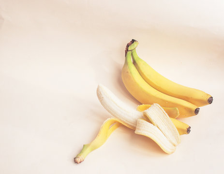 Bananas on a light paper background. Candid, copy space.